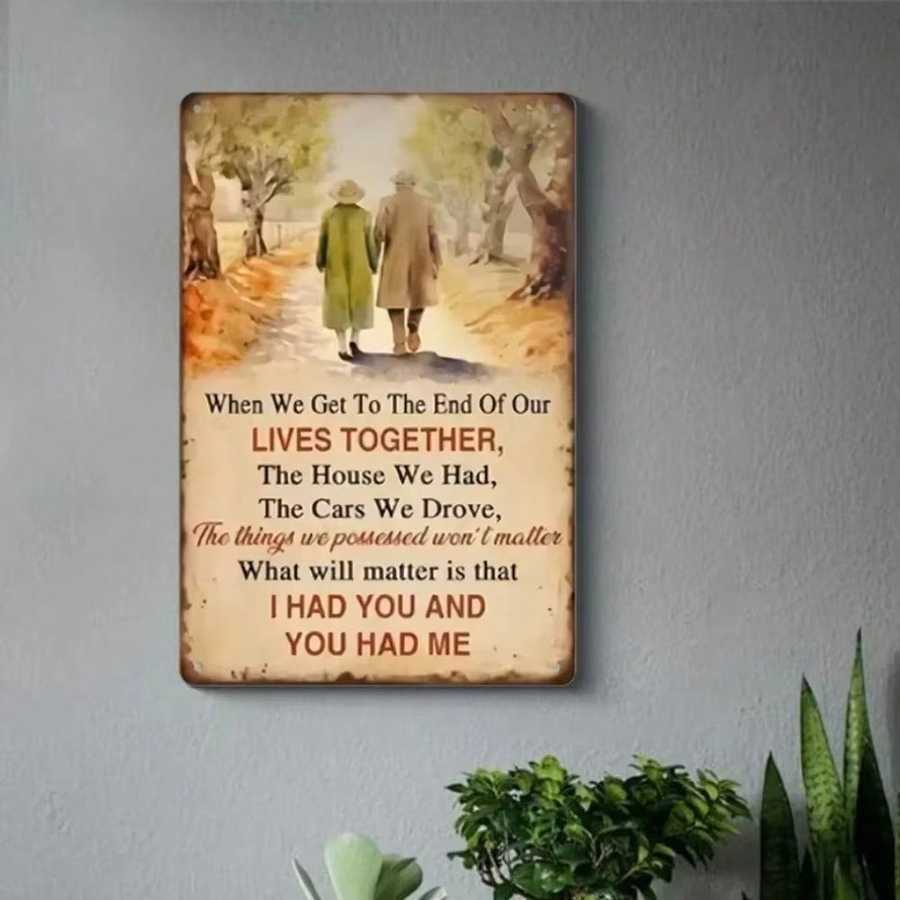 Aluminum wall art with vintage couple and love quote, mounted on a gray wall, ideal for home or café ambiance.