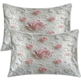Two decorative pillows with floral patterns on a white background