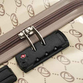 Close-up of a suitcase handle with a brand logo on a patterned background