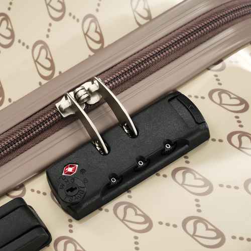 Close-up of a suitcase handle with a brand logo on a patterned background