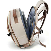 An open backpack shown from a three-quarter angle, revealing its interior compartments, laptop sleeve, and adjustable shoulder straps. The backpack features a cream-colored exterior with tan accents and a blue-gray interior lining.