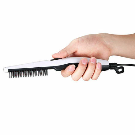 Hand holding electric hair straightening comb for styling beards and hair