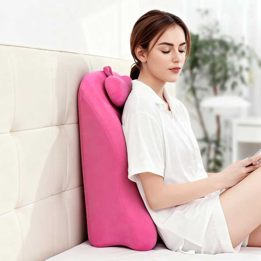 Woman relaxing against pink memory foam posture support pillow, promoting upright posture and lumbar support while seated.