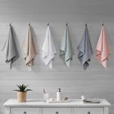 Cotton Waffle Jacquard Bath Towels in 6 colors hanging on hooks, showcasing full color range of the 6 piece quick drying towel set.