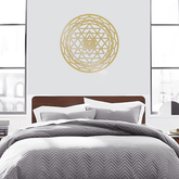 Gold CIFbuy Aluminum Mandala Wall Art centered above a bed with gray chevron bedding. Perfect for minimalist and spiritual decor themes.