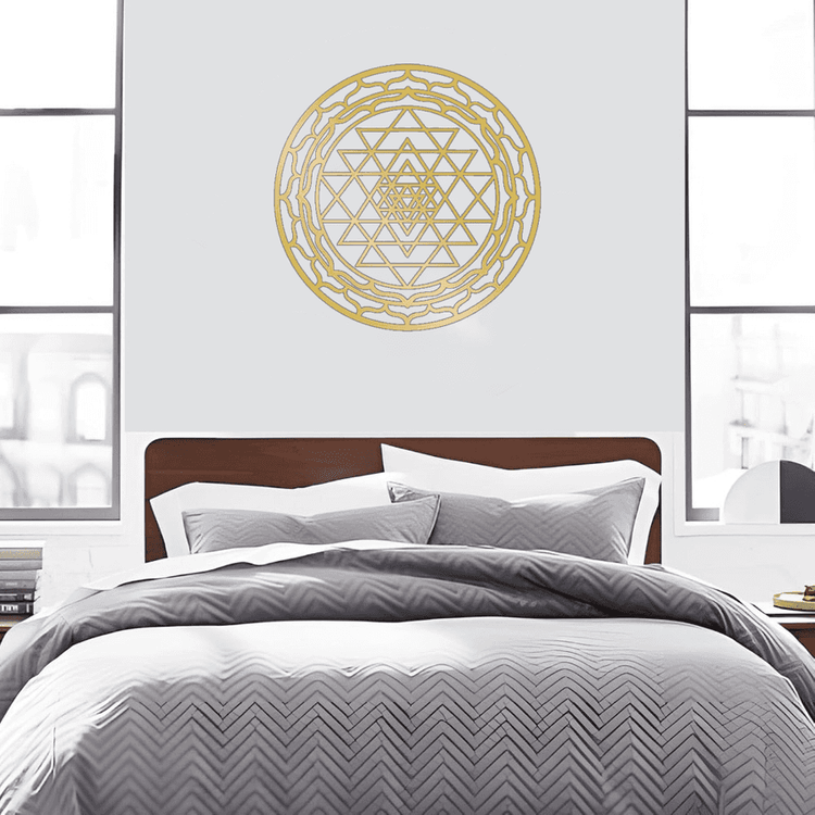 Gold CIFbuy Aluminum Mandala Wall Art centered above a bed with gray chevron bedding. Perfect for minimalist and spiritual decor themes.