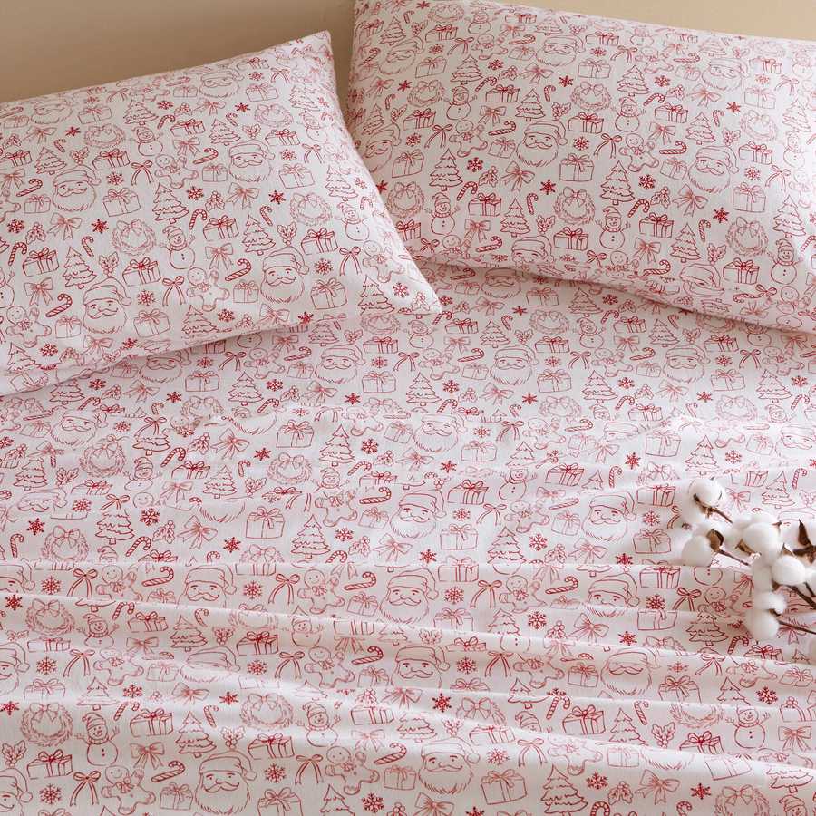 Holiday Doodles - Twin XL Cotton Flannel Sheet Set close-up of pillowcases and sheets with red festive doodles for a cheerful holiday bedroom look.
