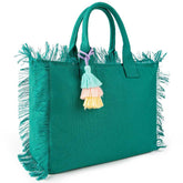 Green handbag with fringe details and colorful tassels on a white background