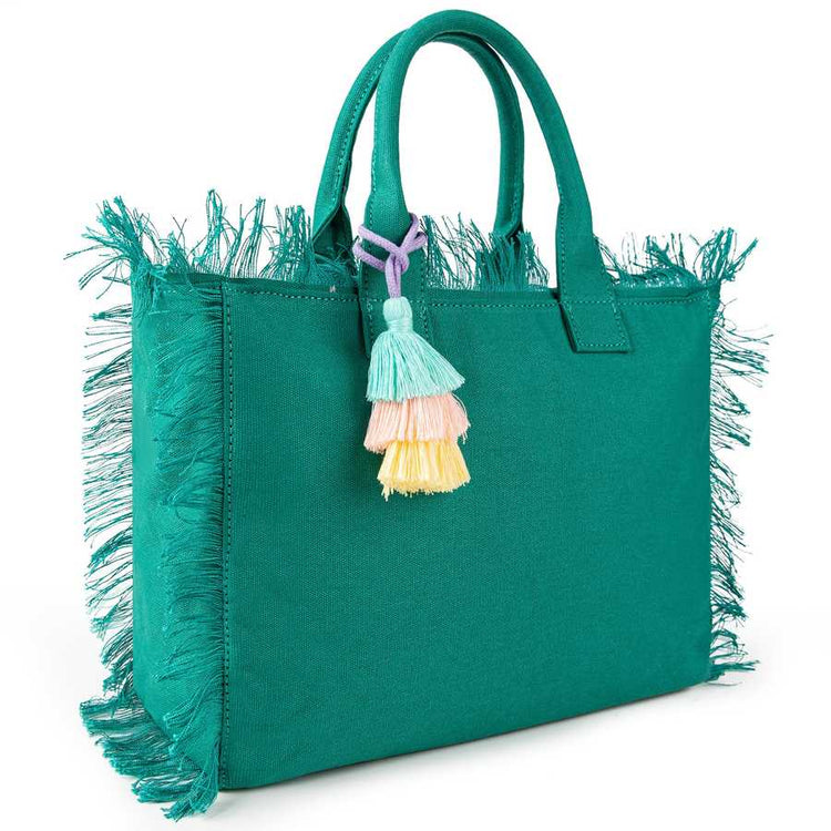 Green handbag with fringe details and colorful tassels on a white background