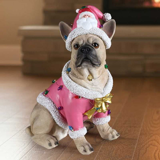 French Bulldog statue in pink Santa outfit, close-up
