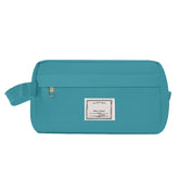 Teal toiletry bag with a label on a white background