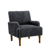 Gray ribbed armchair with wooden legs in a room with large windows and a plant.