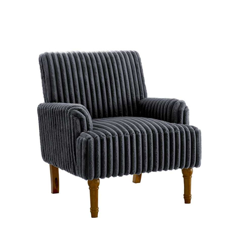 Gray ribbed armchair with wooden legs in a room with large windows and a plant.