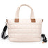 Beige quilted handbag with brown leather accents on a white background