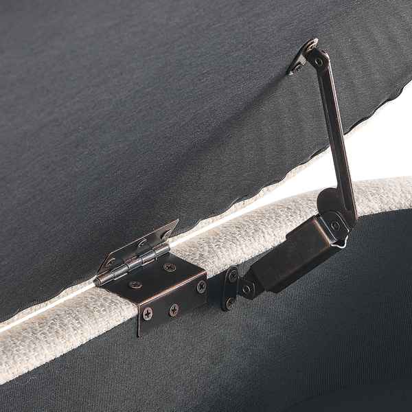 Close-up of a metal hinge on a dark fabric surface