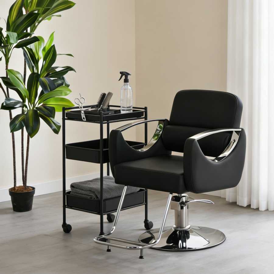 Black salon chair with a cart and plant in a room setting