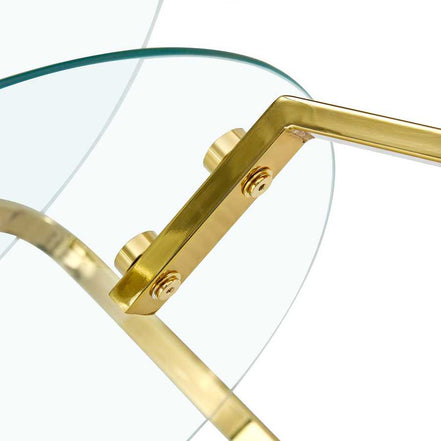 Angled view of gold metal support and suction cup mount on vintage glass coffee table, ensuring stability.