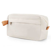 Beige toiletry bag with brown straps on a white background