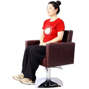 Model seated on 360° swivel salon chair with PU leather finish, demonstrating comfort and ergonomic support for clients.