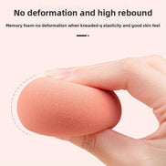 Close-up of peach beauty blender from the Pink Crystal Makeup Set showing high elasticity and soft memory foam for smooth blending.