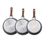 Bottom view of 3 piece aluminum skillet set showing SS430 starry base and wood-style handles.