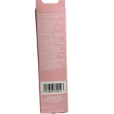 Back of a pink cosmetic packaging with text and barcode on a white background