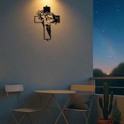 Metal Cross Wall Art Decor with Jesus face silhouette displayed on a balcony wall. Weather-resistant metal perfect for outdoor use.