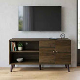 Wooden TV stand with a mounted flat-screen TV, featuring open shelves, a small clock, and decorative items, in a bright living room