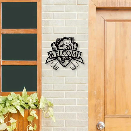 Black fish wall decor with trees and 'Welcome' banner on brick wall
