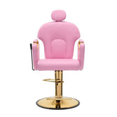 A pink salon barber chair with gold-finished metal hardware, featuring a rounded backrest, armrests, a headrest, and a circular swivel base on a white background.
