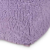 Close-up of a purple textured bath mat on a white background