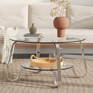 31.5'' Vintage Metal Frame Coffee Table with clear glass top and shelf, featuring curved chrome legs in a minimalist setting.