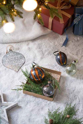 Egg Christmas ornaments with greenery and gifts