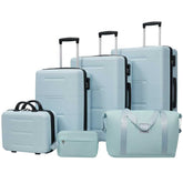 Set of light blue suitcases and travel bags on a white background