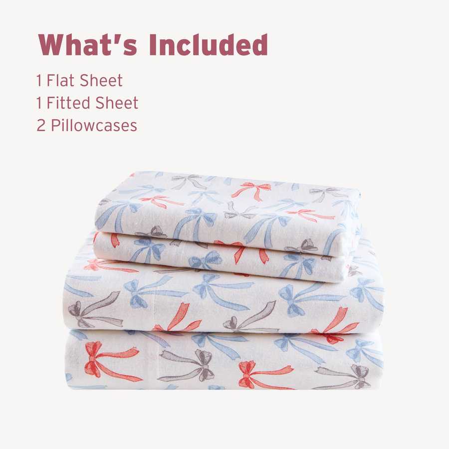 Folded Happy Bows Twin XL Cotton Flannel Sheet Set showing 1 flat sheet, 1 fitted sheet, and 2 pillowcases with bow pattern.