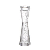 A clear glass hourglass-shaped tumbler with embedded air bubbles, shown on a plain white background.