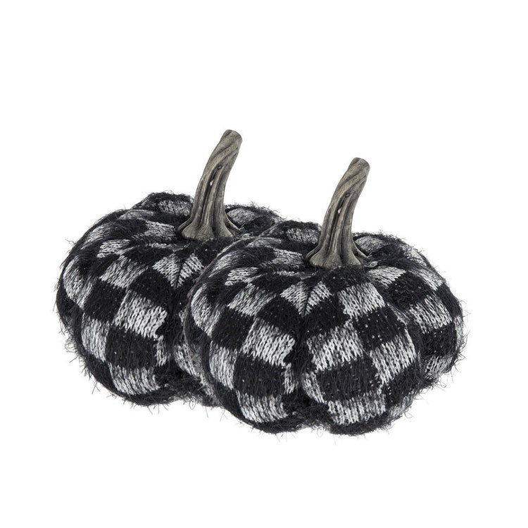 Two small decorative pumpkins with a black and white checkered knit pattern and faux gray stems, shown on a plain white background.