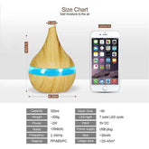 Wooden diffuser with blue band next to an iPhone 6s for size comparison, with a size chart overlay.