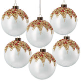 Set of six white Christmas ornaments with gold and red decorations on a white background