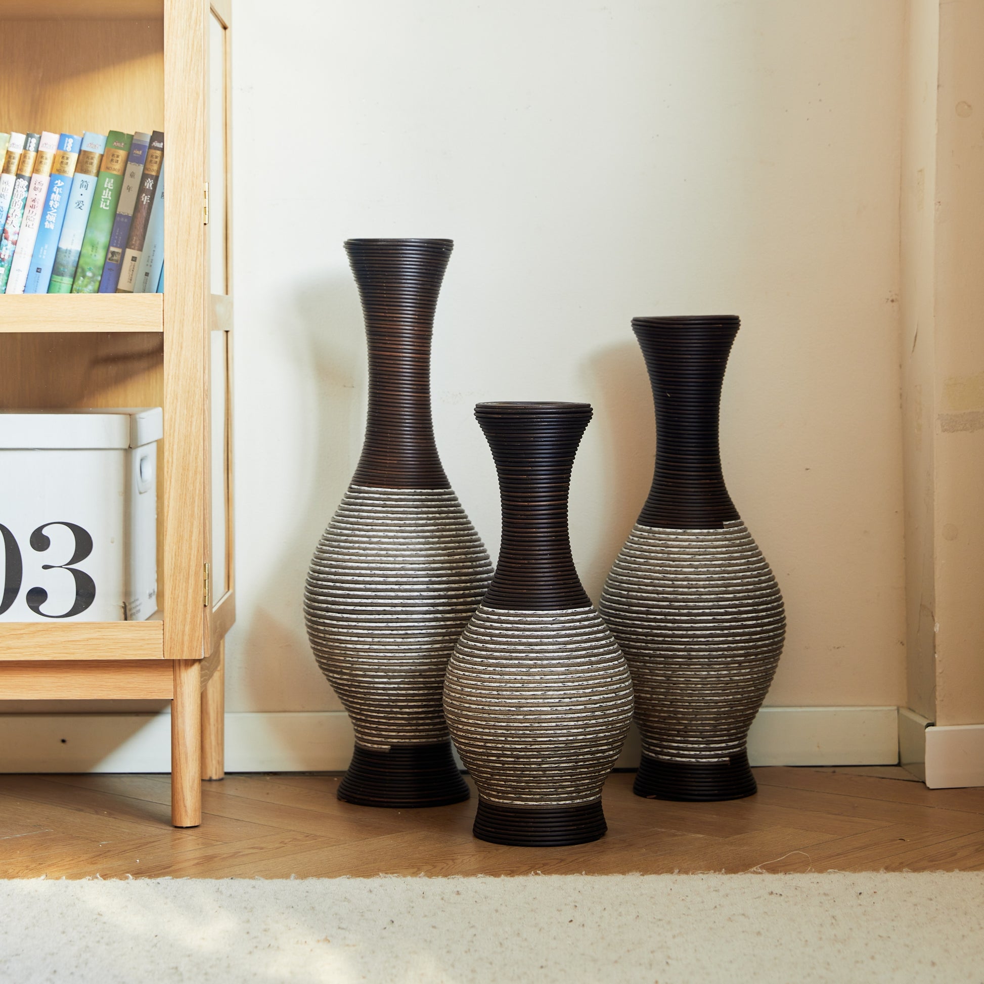Brown floor vase set of 3 beside a bookshelf, ideal for modern home décor and showcasing tall floral arrangements.