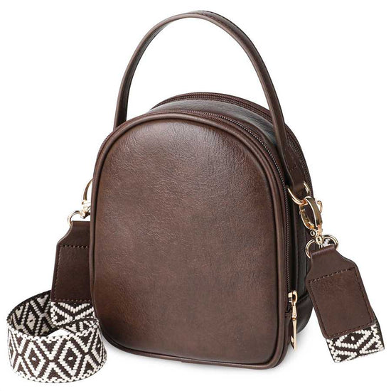 Brown leather handbag with a patterned strap on a white background