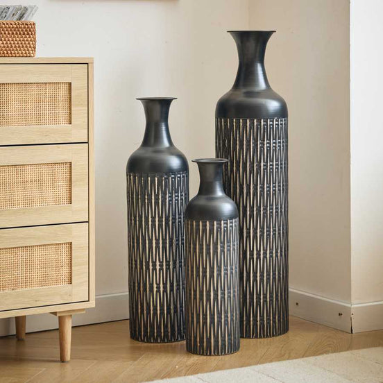 Black floor vases set of 3 with unique zigzag texture, placed next to a light wood dresser in a cozy home setting.