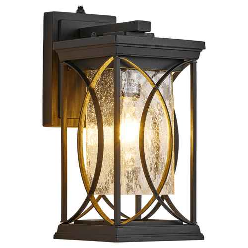 Outdoor wall sconce with a black metal frame, warm gold-toned accents, and a textured clear glass shade glowing with a warm light, shown on a white background.