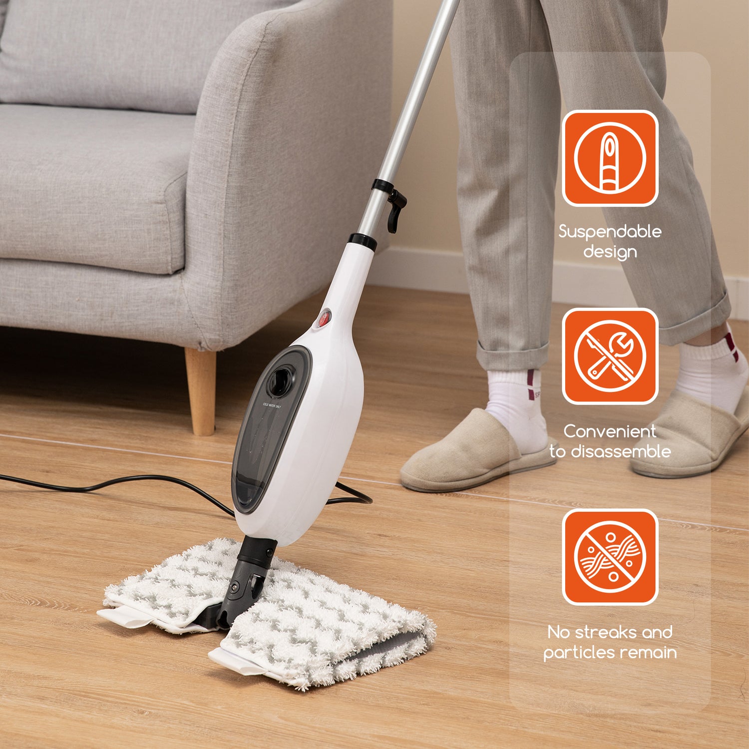 A cordless steam mop being used on a light wood floor in a living room setting, with a person&