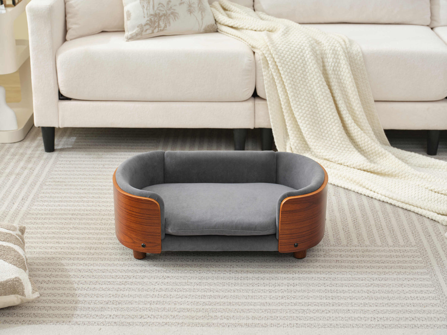 Scandinavian Elevated Dog Bed without pet, showing orthopedic velvet cushion and solid wood frame in modern setting.
