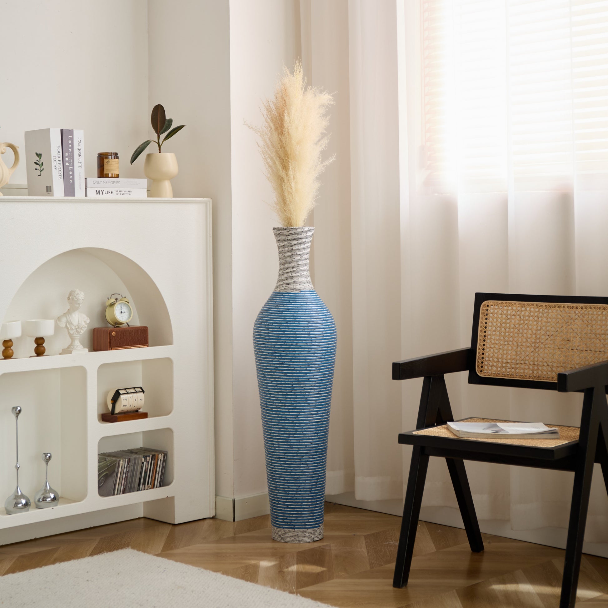 Blue and gray 39-inch floor vase decor with pampas grass placed in a bright, modern living room corner for visual appeal.