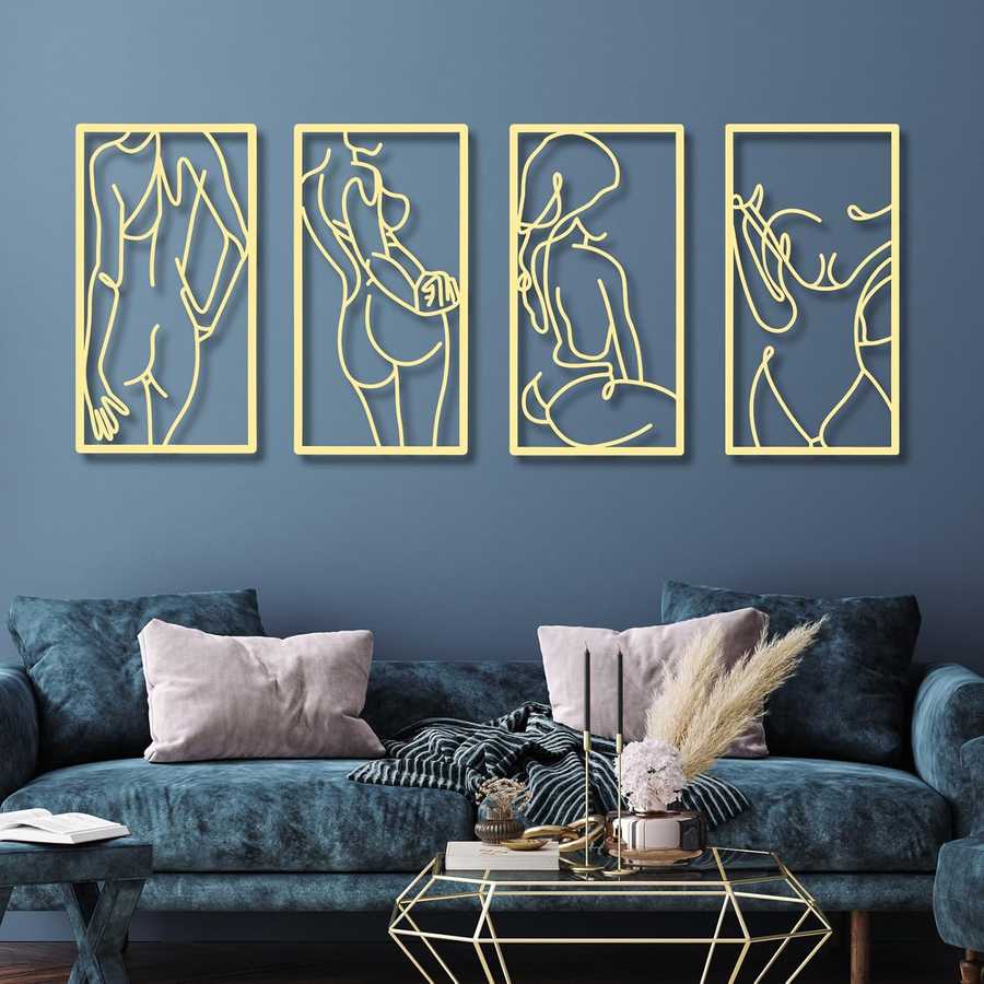 Four gold line art wall hangings on a blue wall above a dark blue sofa.