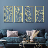 Four gold line art wall hangings on a blue wall above a dark blue sofa.