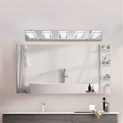 A modern rectangular bathroom mirror with an integrated LED light strip above it, mounted on a light beige wall above a white countertop and sink.