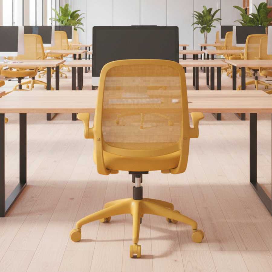 Yellow office chair in a modern office setting with desks and plants.